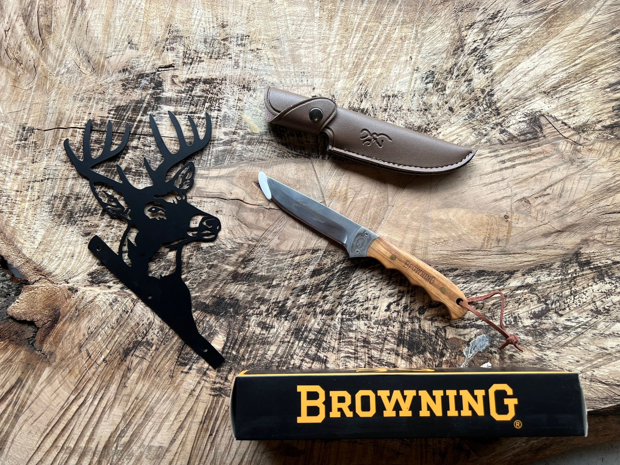 A hunting knife showcased against a backdrop of rugged wilderness.