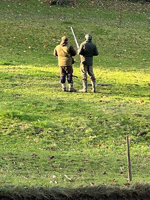 Image of two hunters in a field